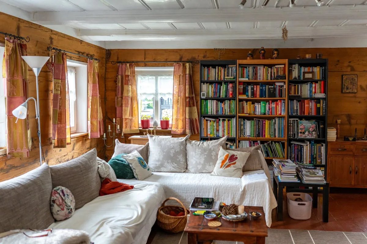 Tall white bookshelves used as vertical storage in a small living room
