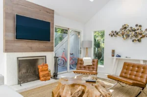 Peel-and-Stick Wall Panels for Renters: 7 Picks That Look Real (and Three That Don't) Living room accent wall with faux wood plank peel-and-stick panels mounted behind a wall-mounted TV