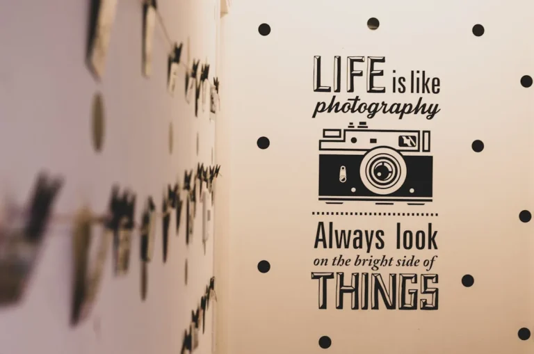 Wall with vinyl quote lettering and camera silhouette decal