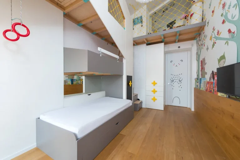 Playful kids room with a wall mural and climbing equipment