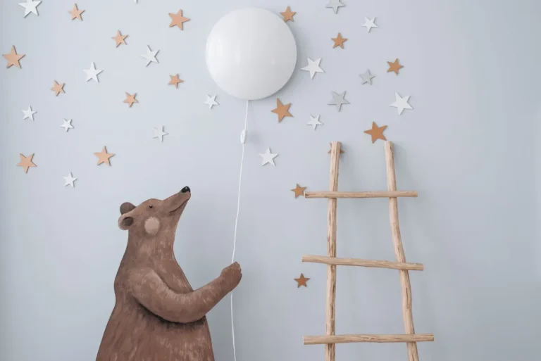 Nursery wall with star decals and a wooden bear figure