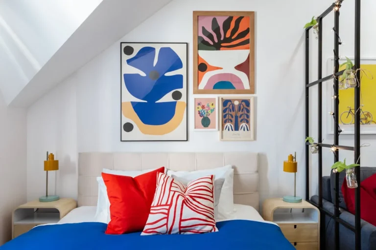 Bright bedroom with abstract gallery wall prints above a bed