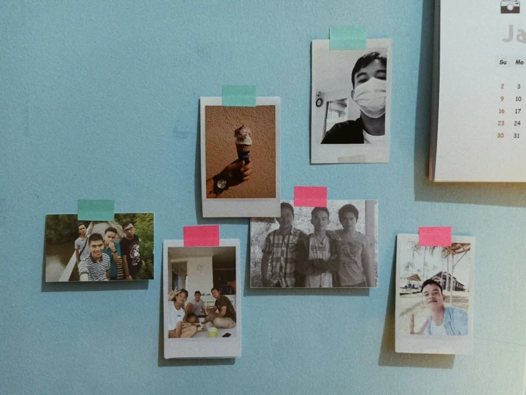 Polaroid photos taped to a light blue wall with colorful washi tape strips