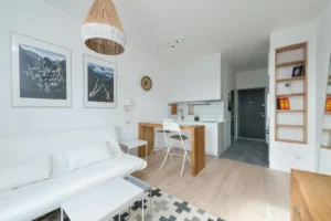 What to Buy First for Your First Apartment (A Smart Buying Order on Any Budget) Bright studio apartment with a compact sofa and kitchenette
